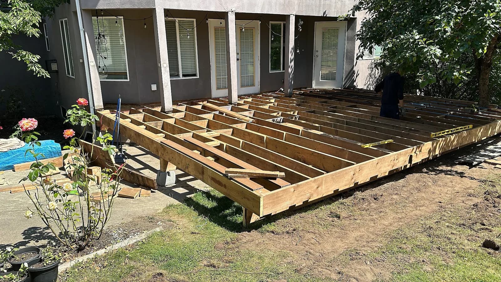 Backyard deck with surface boards removed and the joist layout exposed
