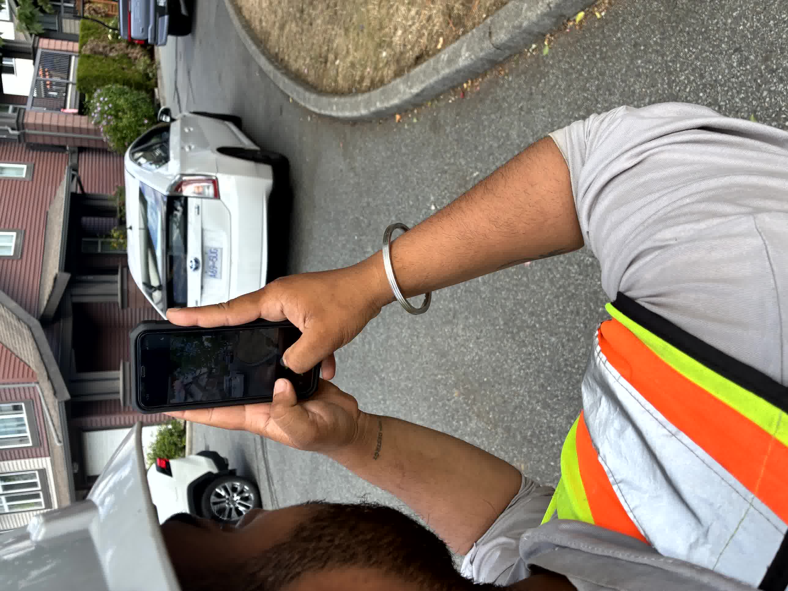 Construction worker photographing site conditions with a mobile phone